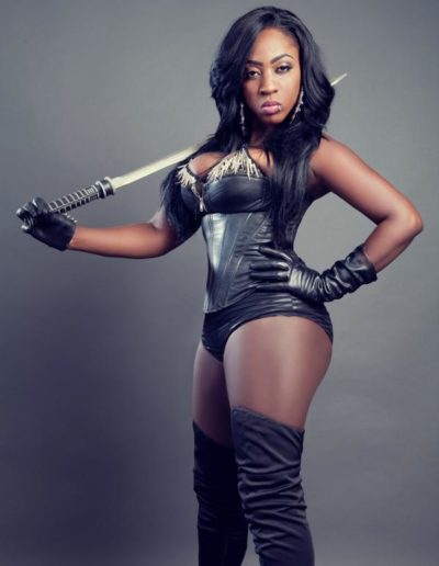 spice Jamaican artist posing in lingerie and sword